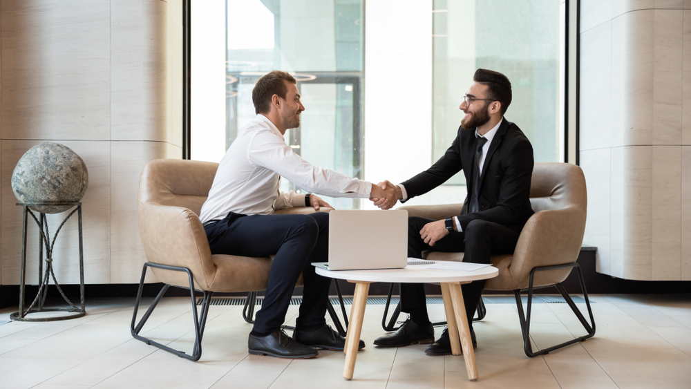 HR manager greeting applicant before job interview process